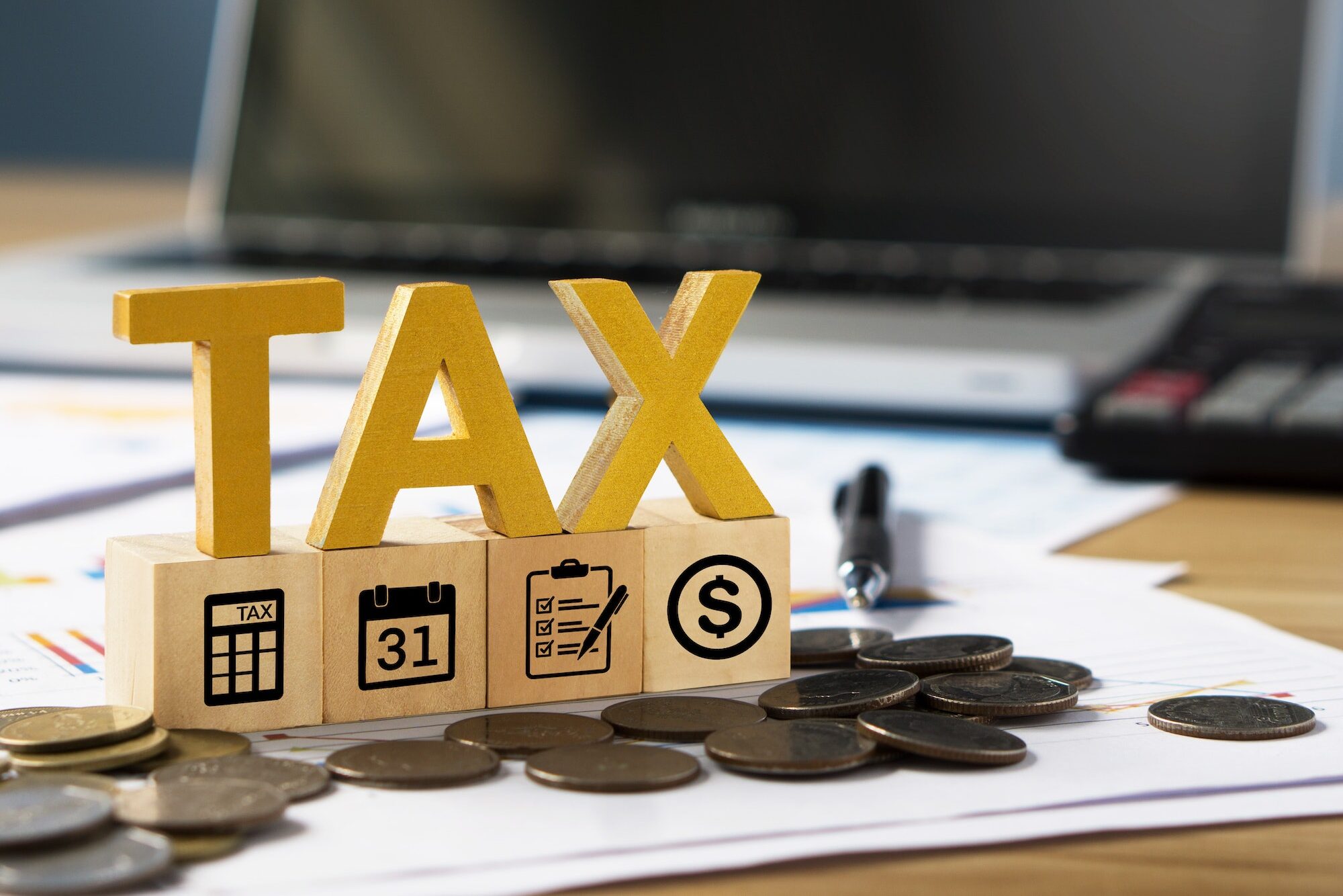 Tax wooden letter and tax icon on wooden block.Pay tax in new year.